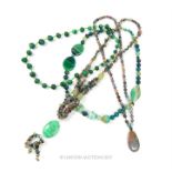A collection of green semi precious stone necklaces.