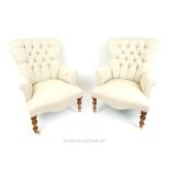 A pair of contemporary Victorian style armchairs, upholstered in light grey button back fabric