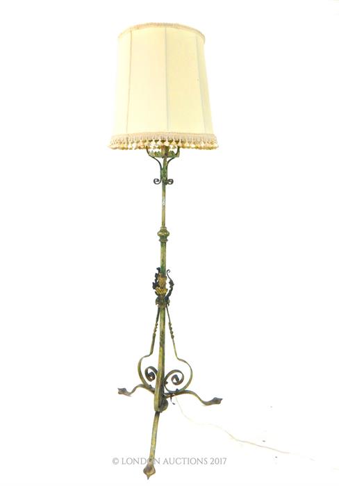 A painted wrought iron standard lamp, with a shade