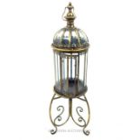 A brass framed storm lantern on stand; 109 cm high