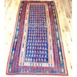A kelim carpet, having repeated motifs on a blue field