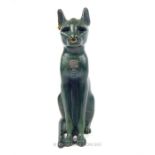 A green painted sculpture of the Egyptian goddess Bastet