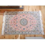 A fine Persian Nain silk and wool rug with pink ground; 145cm x 95cm.