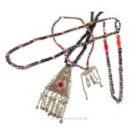 A Bedouin coloured glass bead necklace with large triangular white metal pendant, with three other