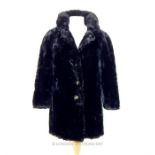 A ladies, authentic, black fur coat with black silk lining