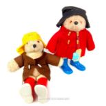 Two Paddington bear soft toys, both with rubber boots.