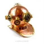 A reproduction deep sea diver style helmet with brass and copper fittings.