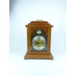 A walnut-cased, reproduction, mantle-clock