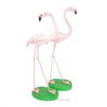 A pair of roughly life-size painted resin figures of flamingos