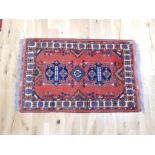A Turkoman rug with red ground with kelim ends; 136cm x 87cm.