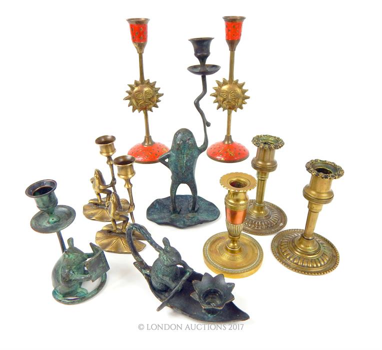 A collection of ten brass and bronzed candlesticks