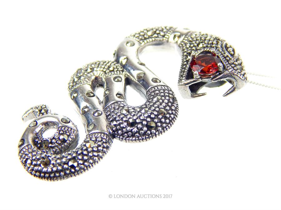 An unusual silver marcasite and large Garnet snake pendant with silver chain, both stamped 925; 5 cm - Image 2 of 2