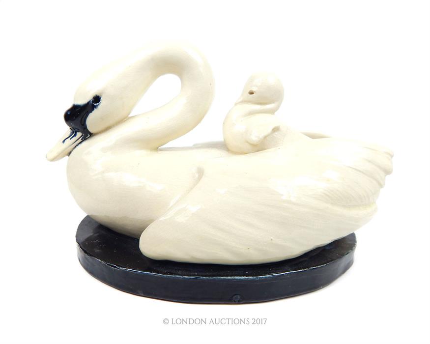 An Art Deco ceramic group of a swan with a cygnet on their back