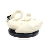 An Art Deco ceramic group of a swan with a cygnet on their back