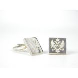 A pair of sterling silver, crested, square-shaped cuff-links