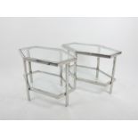 A pair of chromed two tier occasional low tables of geometric form, with plate glass top