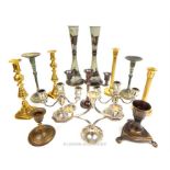 A collection of candlesticks, including Victorian brass examples