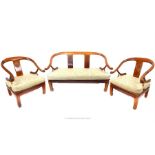 A Chinese hardwood three piece suite consisting of a two seater sofa and a pair of armchairs