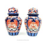 A pair of oriental, Imari pattern, lidded vases