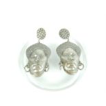 A Fine Pair of Silver Earrings shaped as African Woman's Face from either Nigeria or the Congo.