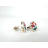 A pair of sterling silver and hand-painted, ceramic, oval, plaque cuff-links