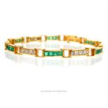 A diamond and emerald bracelet stamped "18k"; 17cm long.