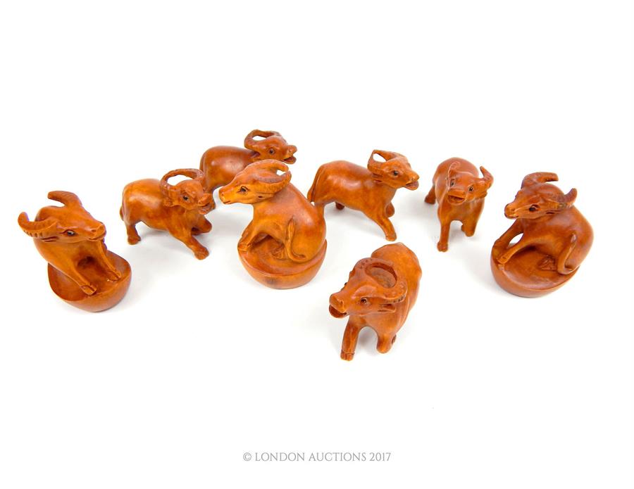 A collection of eight carved wooden netsuke in the form of animals