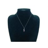 A 9 ct white gold pink sapphire and diamond pendant and chain