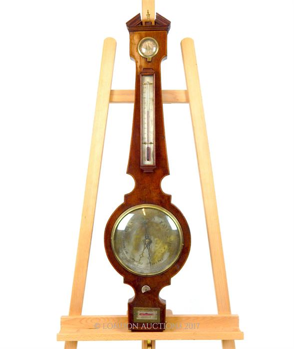 An Edwardian mahogany and inlaid barometer, having a silvered dial