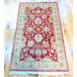 A Ziegler rug decorated with palmettes on a terracotta field