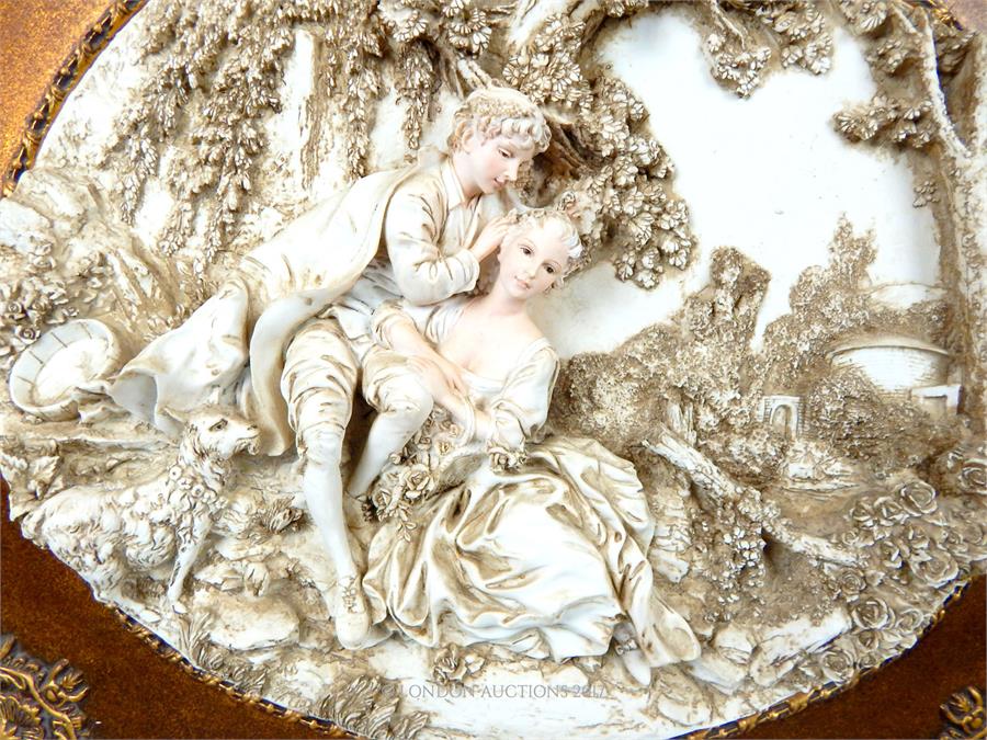 An oval decorative plaque depicting young lovers in relief, in a gilt frame - Image 2 of 2