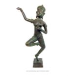 An Indonesian dancing female figurine in a bronzed metal; 49 cm high.