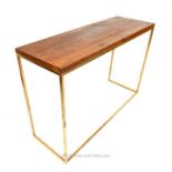 A contemporary gilt metal console table, having a rectangular stained pine top