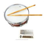 A New Era snare drum, having Carlton drumsticks, together with a white Stylophone