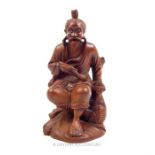 An early 20th century, Japanese, hand-carved boxwood figure of a seated gentleman