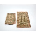 A pair of Caucasian prayer rugs, with repeating designs on an ivory field