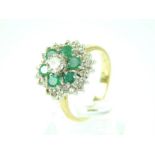 An emerald and diamond ring with 18ct yellow gold band; size N/O.