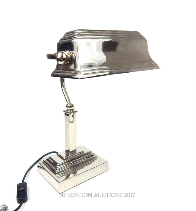 A contemporary chromed bankers desk lamp with adjustable shade