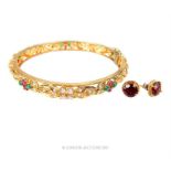 A pair of 9 ct yellow gold, garnet, stud earrings with a gem-set, yellow-metal bangle