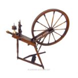 A Georgian fruitwood spinning wheel, with many turned sections