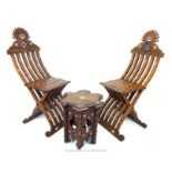 A pair of late 19th / early 20th century Syrian hardwood folding chairs and a table