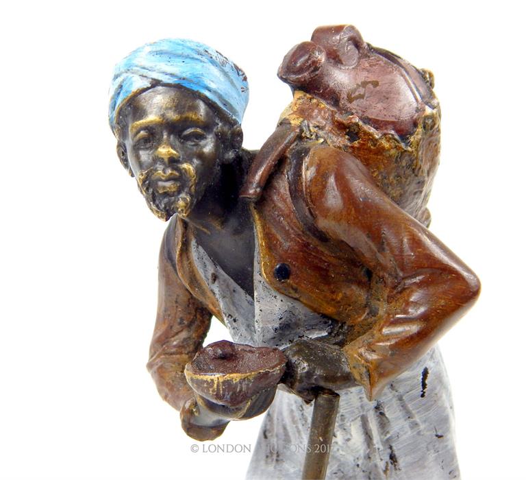 A painted bronzed metal figurine of an Asian gentleman carrying water; indistinctly signed base; - Image 2 of 3