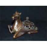 A Chinese bronze incense burner in the form of a seated horse