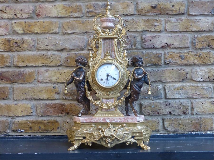 An Italian, 20th century, gilt metal and pink marble mantle clock and garniture set