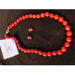 A sterling silver and red hardstone bead necklace and a matching pair of stud earrings