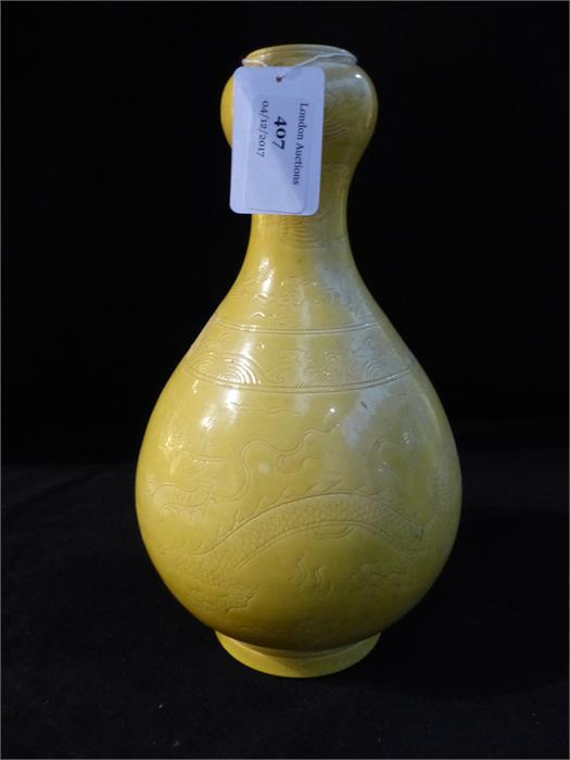 A Chinese vase with an Imperial yellow glaze and incised detail (chip to the base), 26 x 15 x 15cm.