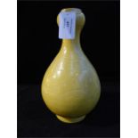 A Chinese vase with an Imperial yellow glaze and incised detail (chip to the base), 26 x 15 x 15cm.