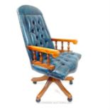 A blue leather office chair, having studded back and seat