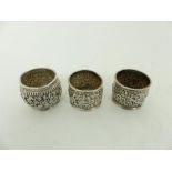 Three, Indian silver napkin rings, with floral, repousse decoration