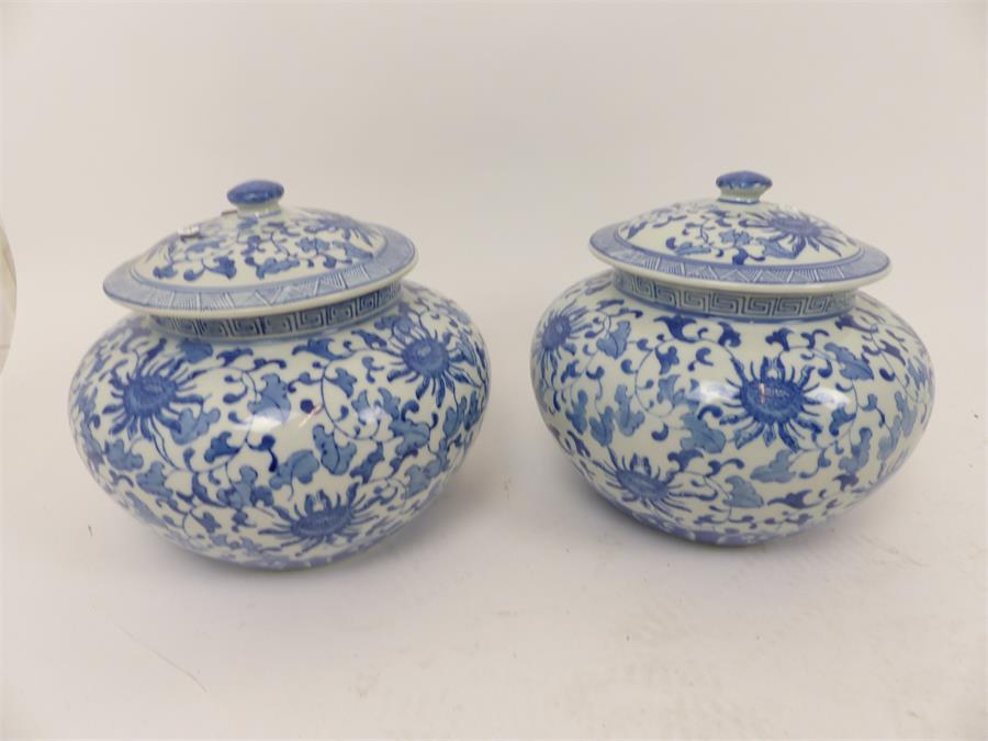 A pair of Chinese blue and white jars with covers